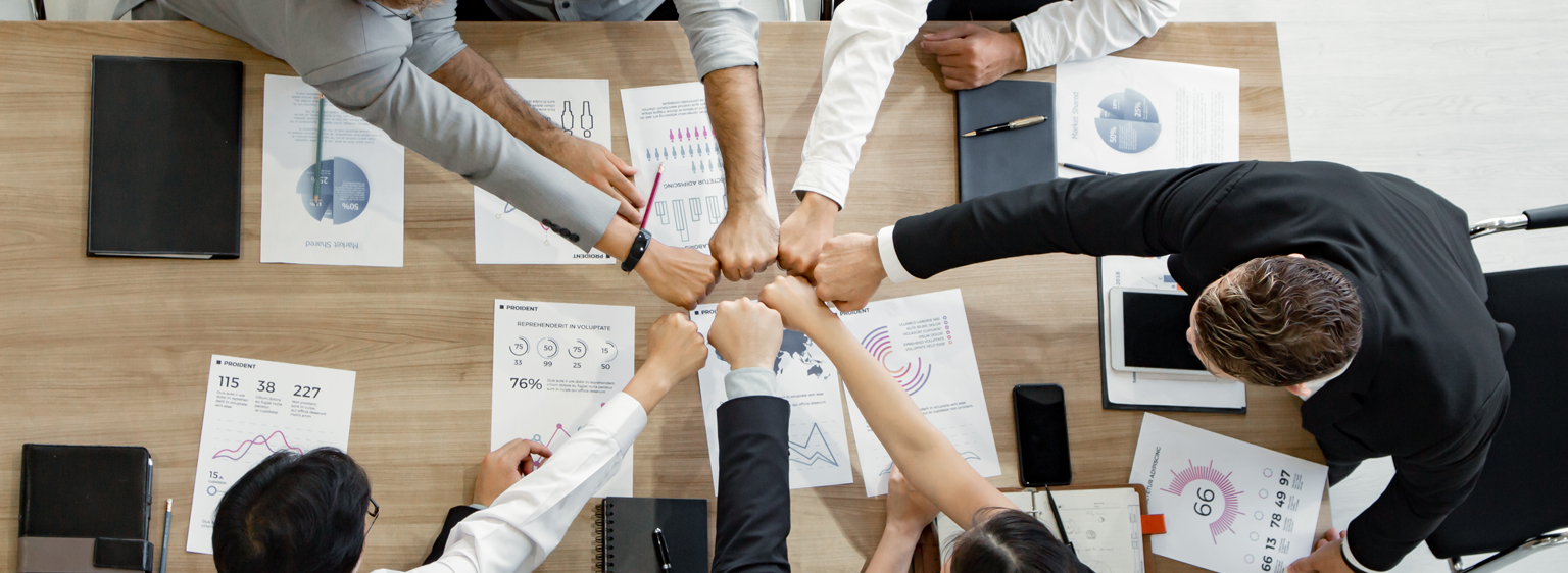 hands at a table working together